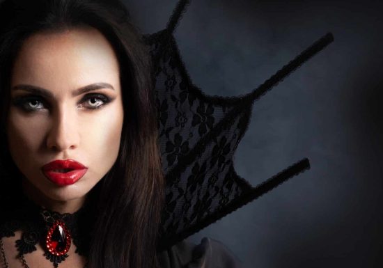 Halloween Vampire Woman portrait Halloween Vampire Woman portrait. Beautiful Glamour Fashion Sexy Vampire Lady with long black hair, beauty make up and costume