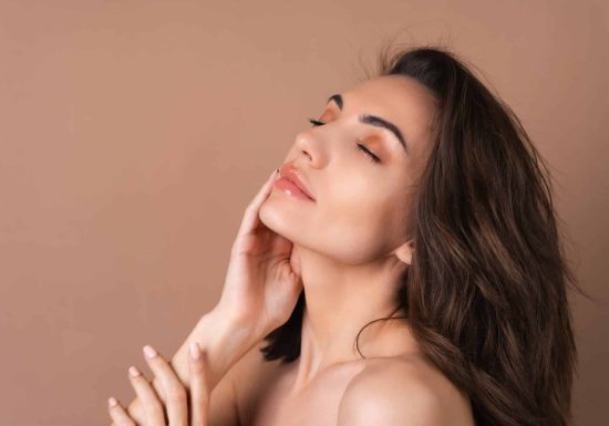 Close-up beauty portrait of a topless woman with perfect skin and natural make-up